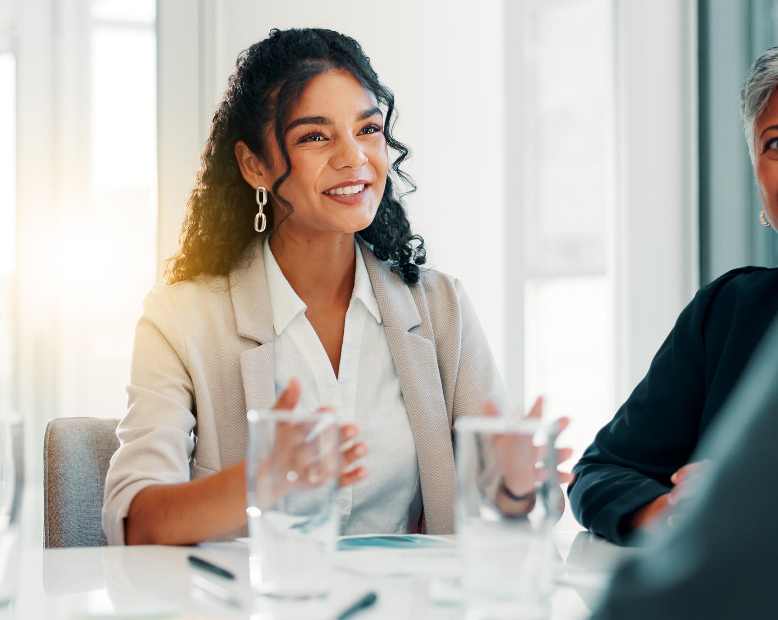 A woman with curly hair and earrings smiles while engaging in a discussion at a conference table, with two other participants partially visible. Natural light fills the background, creating a warm ambiance. Our Employee Benefits Advice includes: Independent advice from benefits specialists Ensure benefits compliance and governance Dedicated, impartial and specialist benefits support Our team of in-house specialists can offer employee benefits consultancy and advice on a range of services that motivates and retains staff while advising on necessary risk insurances and tax implications.