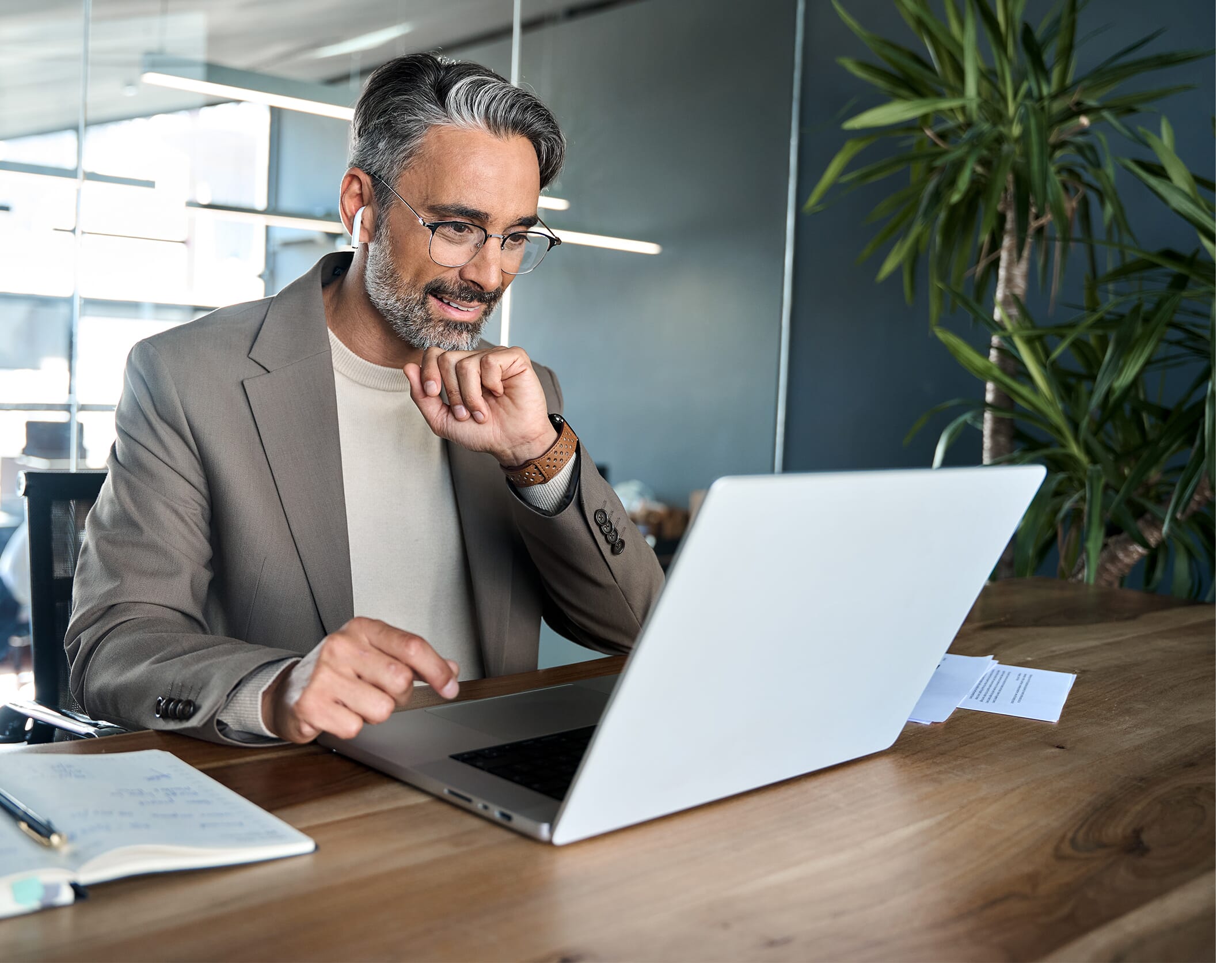 A older smart looking gentleman on a client call about Outsourced HR Support.