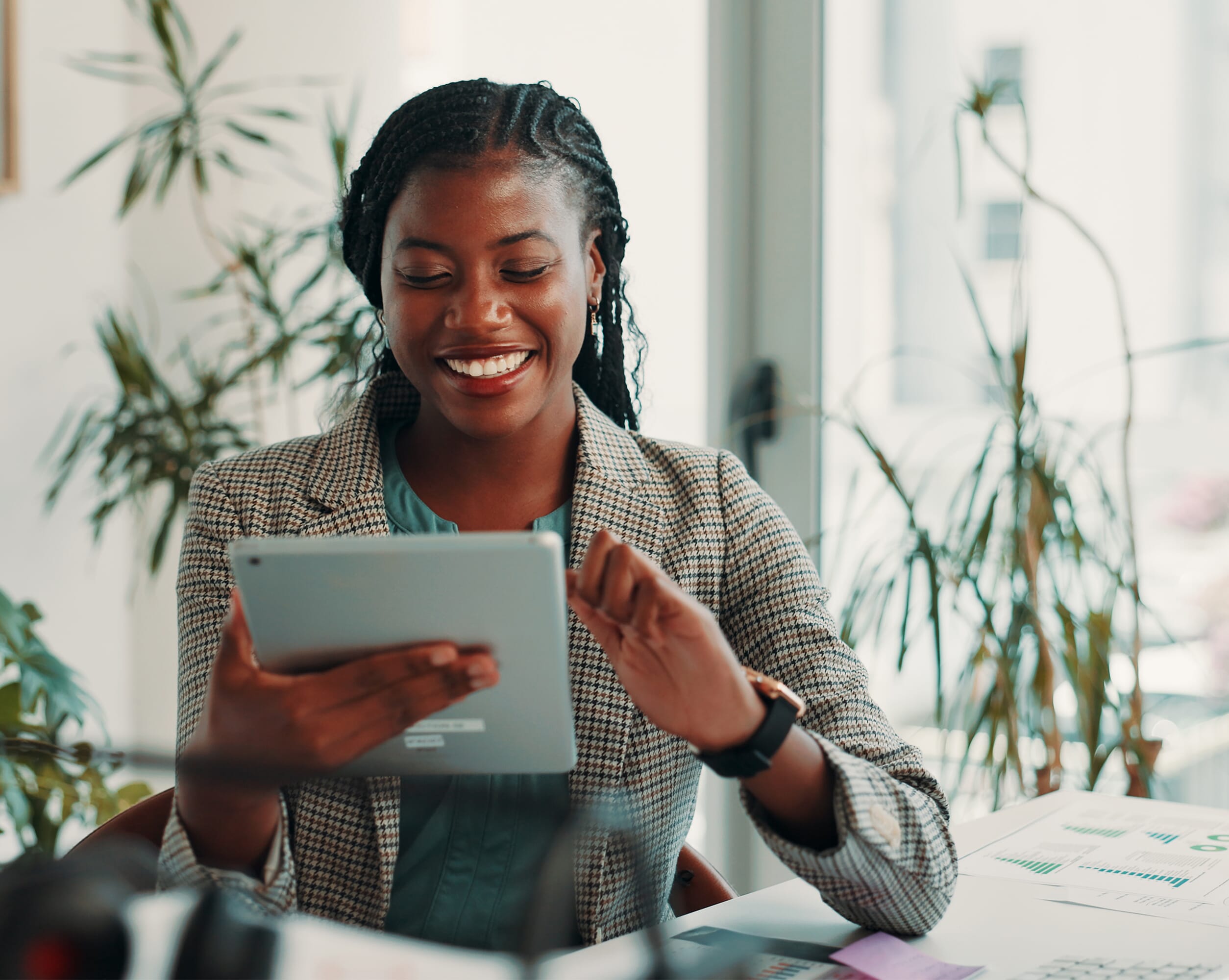 Black Mountain Global Payroll Services, a smartly dressed woman holding a tablet with a smile on her face.