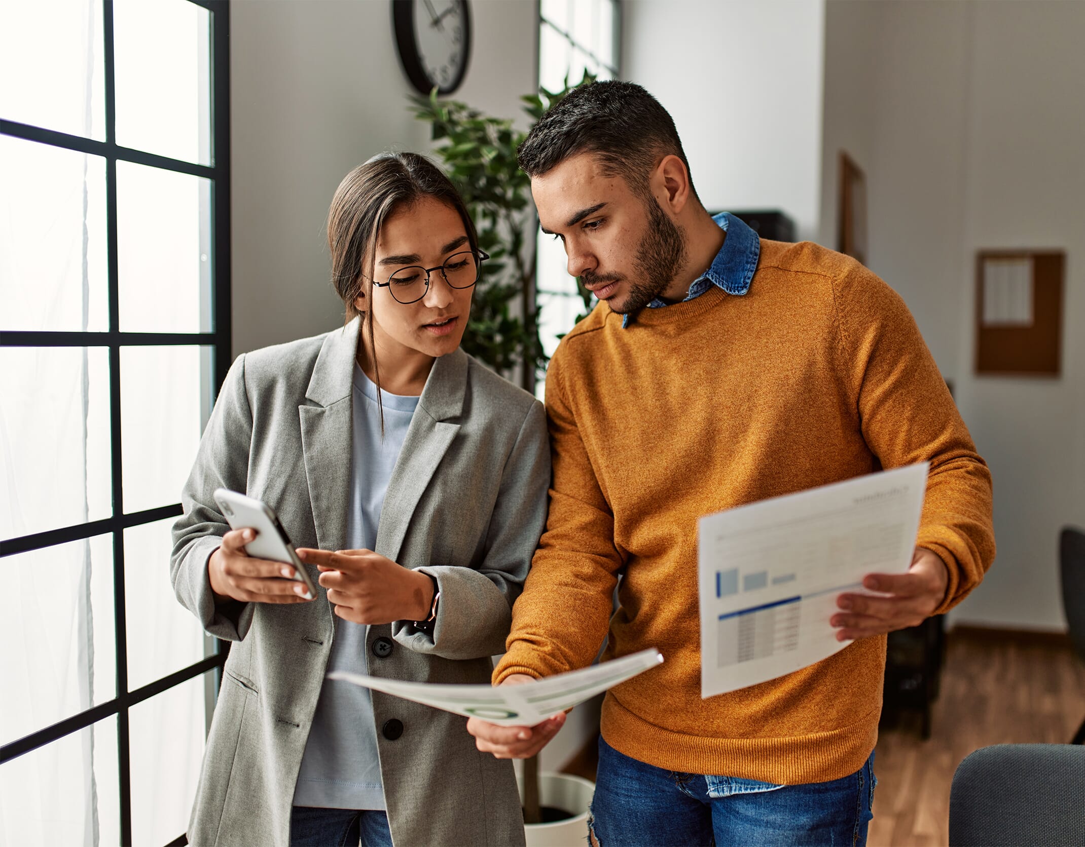 Male-and-female-colleague-discussing-figures