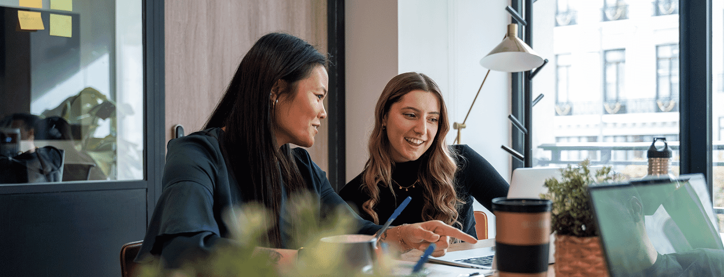 Two-females-discussing-topics-on-laptop